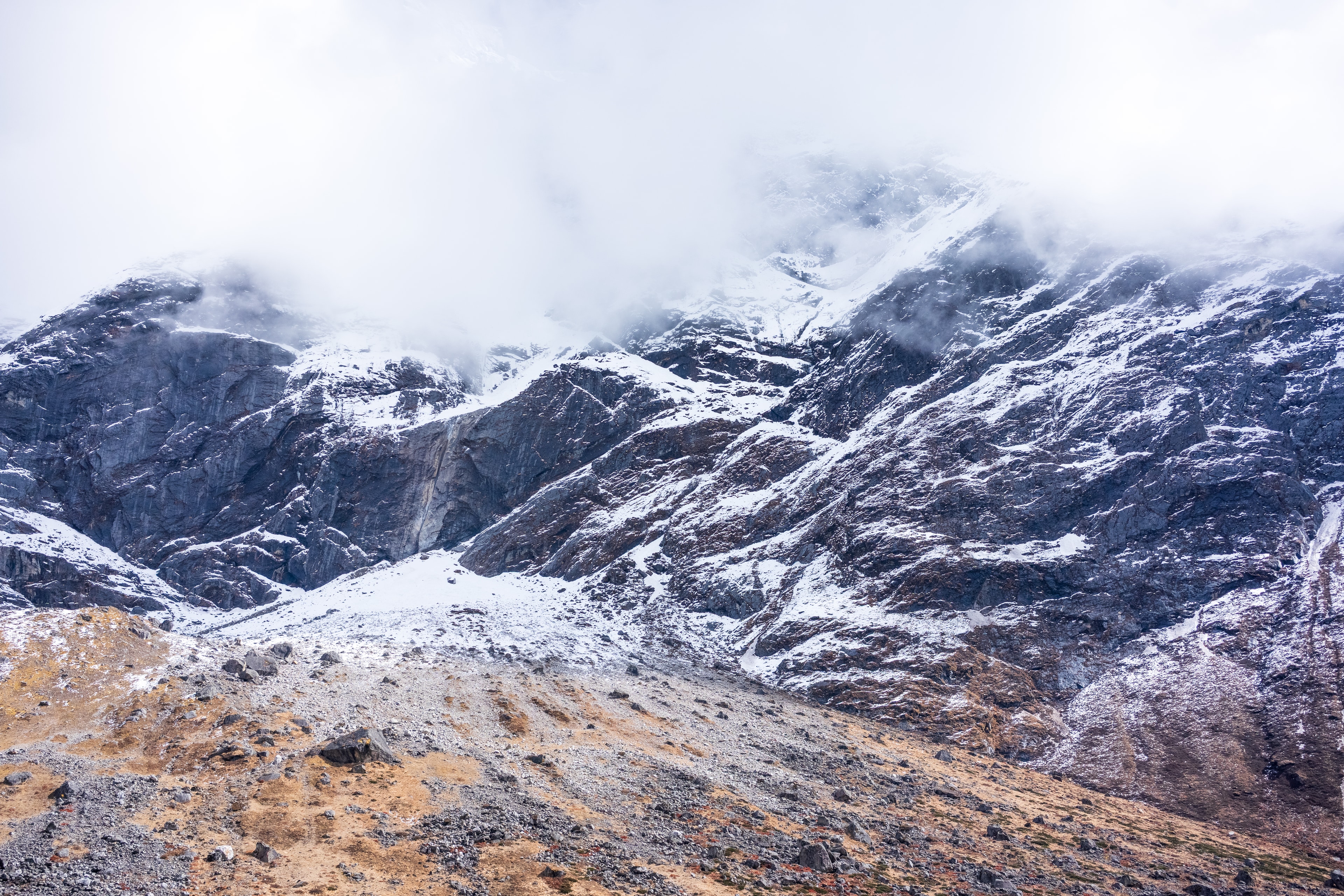 Trekking group resting on a snowy mountain slope in Nepal
